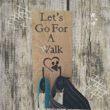 Load and play video in Gallery viewer, Recycled Wood Pet Leash Sign Hanging on Wall
